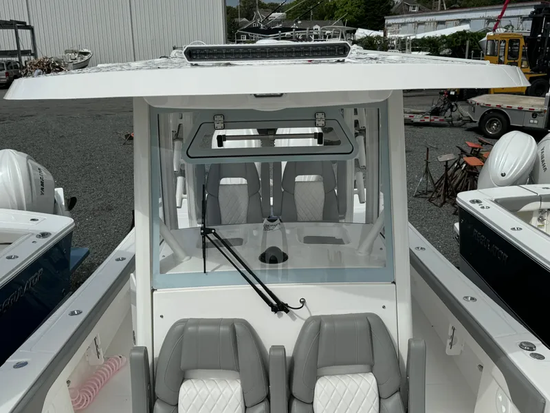 Slide: The Image of 2024 Regulator 30XO boat cockpit with seating and windshield. - 25