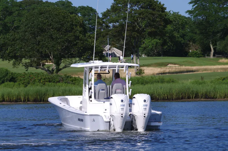 Slide: The Image of 2024 Regulator 30XO boat with twin engines cruising on a lake. - 6