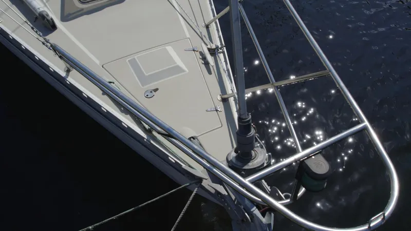 Slide: The Image of 1986 O'Day 39 sailboat bow with sparkling water reflections. - 11