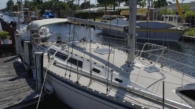 Slide: The Image of 1986 O'Day 39 sailboat docked in a sunny marina. - 13