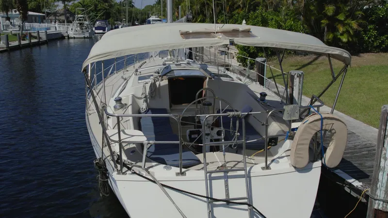 Slide: The Image of 1986 O'Day 39 Aft Cockpit sailboat docked, featuring spacious deck and canopy. - 15