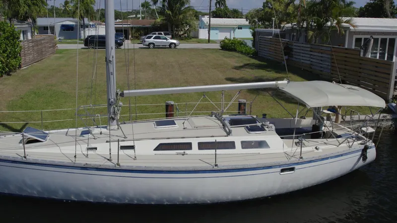 Slide: The Image of 1986 O'Day 39 sailboat with aft cockpit, docked near residential area. - 16