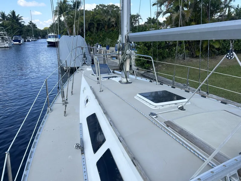 Slide: The Image of 1986 O'Day 39 sailboat on a calm river, surrounded by lush greenery. - 23