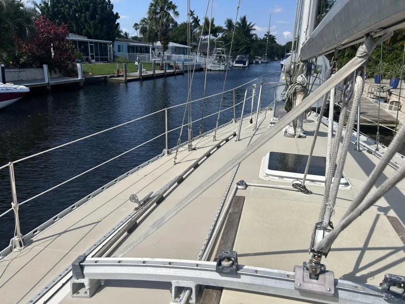 Slide: The Image of 1986 O'Day 39 sailboat on a serene canal, showcasing deck and rigging. - 28