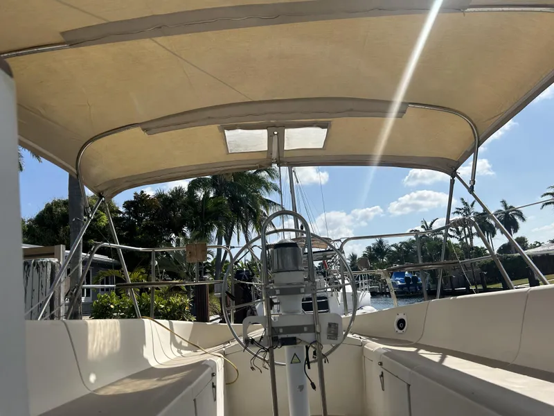 Slide: The Image of 1986 O'Day 39 Aft Cockpit sailboat with canopy, docked under sunny skies. - 31