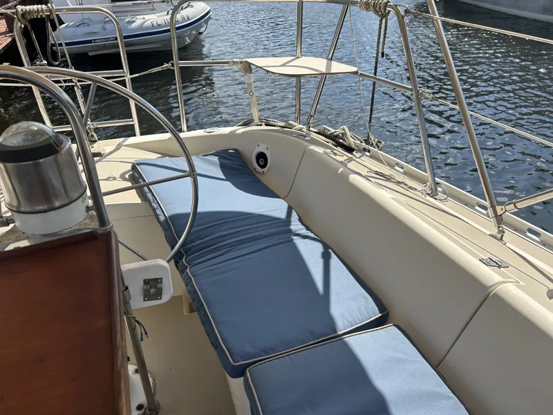 Slide: The Image of 1986 O'Day 39 sailboat aft cockpit with blue cushions and steering wheel. - 35