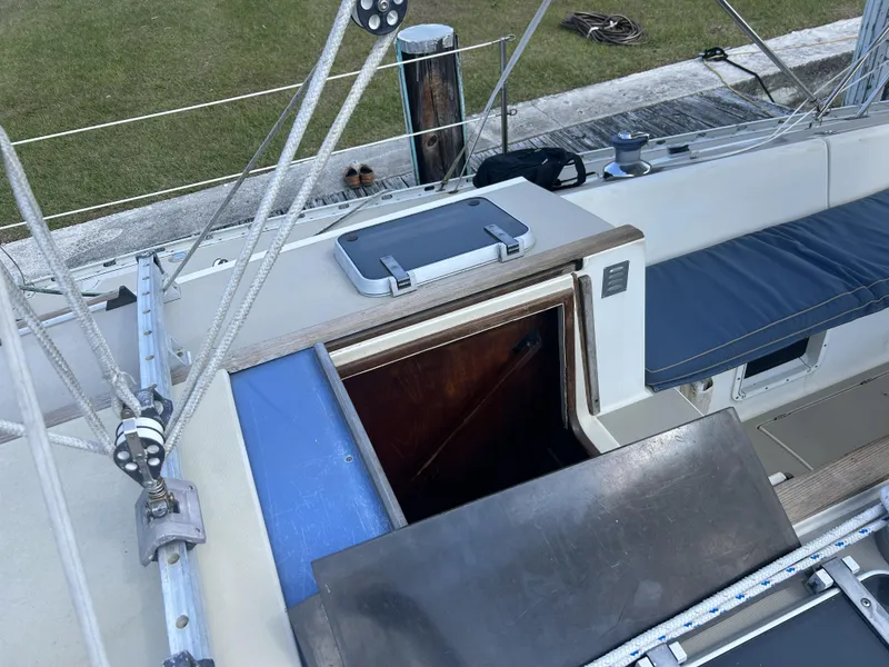 Slide: The Image of 1986 O'Day 39 sailboat aft cockpit with open hatch and visible rigging. - 38