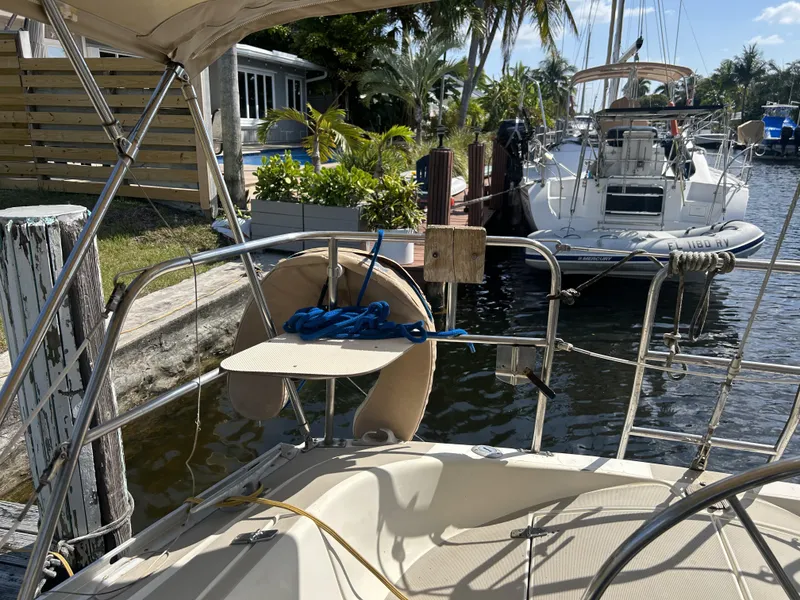 Slide: The Image of 1986 O'Day 39 Aft Cockpit sailboat docked in a sunny marina. - 39