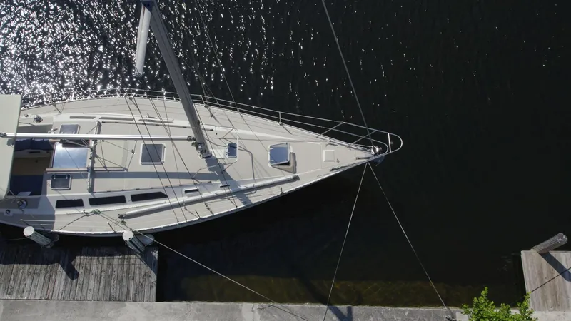 Slide: The Image of Aerial view of 1986 O'Day 39 sailboat docked, showing aft cockpit and sleek design. - 4
