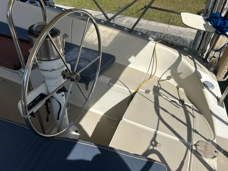 Slide: The Image of 1986 O'Day 39 Aft Cockpit sailboat with steering wheel and seating area. - 42