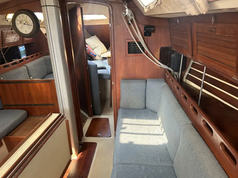 Slide: The Image of Interior of 1986 O'Day 39 sailboat with wood paneling and gray seating. - 47