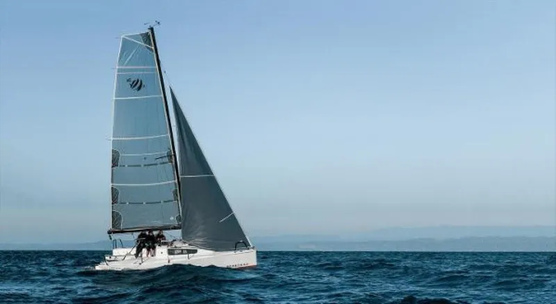 Slide: The Image of 2025 Beneteau First 24 SE sailboat navigating open sea under clear skies. - 8