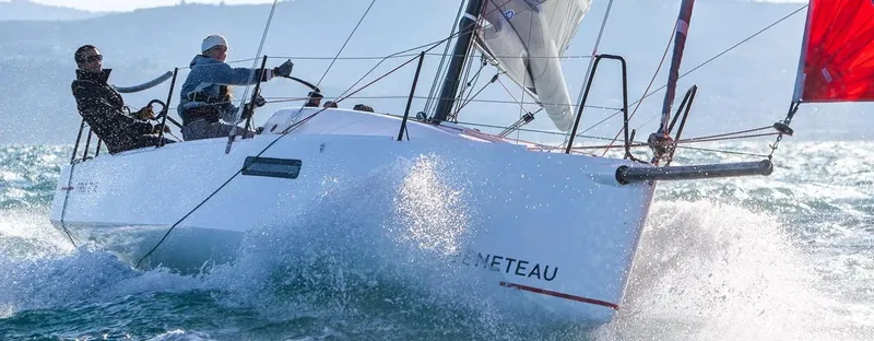 Slide: The Image of 2025 Beneteau First 27 SE sailboat navigating through waves with crew onboard. - 9