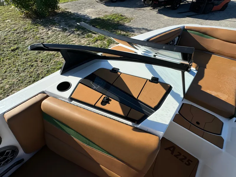 Slide: The Image of 2023 Axis A225 boat interior with tan seats and open windshield. - 15