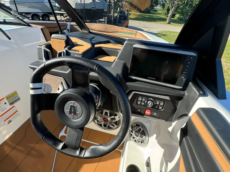 Slide: The Image of 2023 Axis A225 boat dashboard with steering wheel and Garmin display. - 20