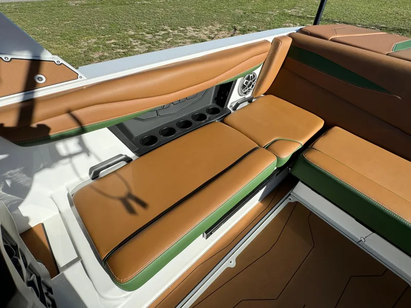 Slide: The Image of 2023 Axis A225 boat interior with brown and green seating. - 22