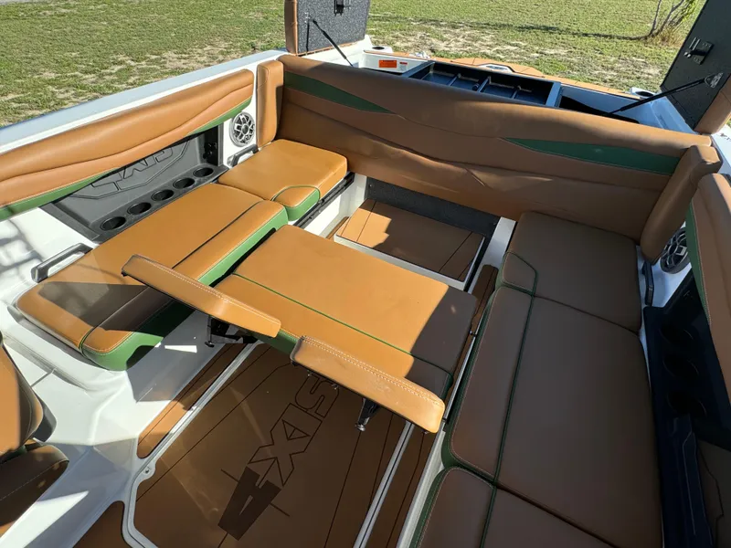Slide: The Image of 2023 Axis A225 boat interior with tan and green seating. - 30