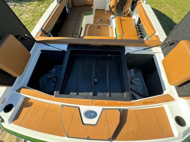 Slide: The Image of 2023 Axis A225 boat interior with open storage compartments and tan seating. - 35
