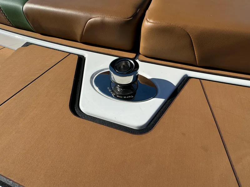 Slide: The Image of 2023 Axis A225 boat interior with brown seating and deck hardware. - 40