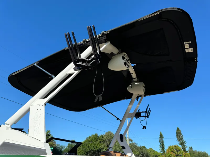 Slide: The Image of 2023 Axis A225 boat with wakeboard tower and speakers against clear blue sky. - 42