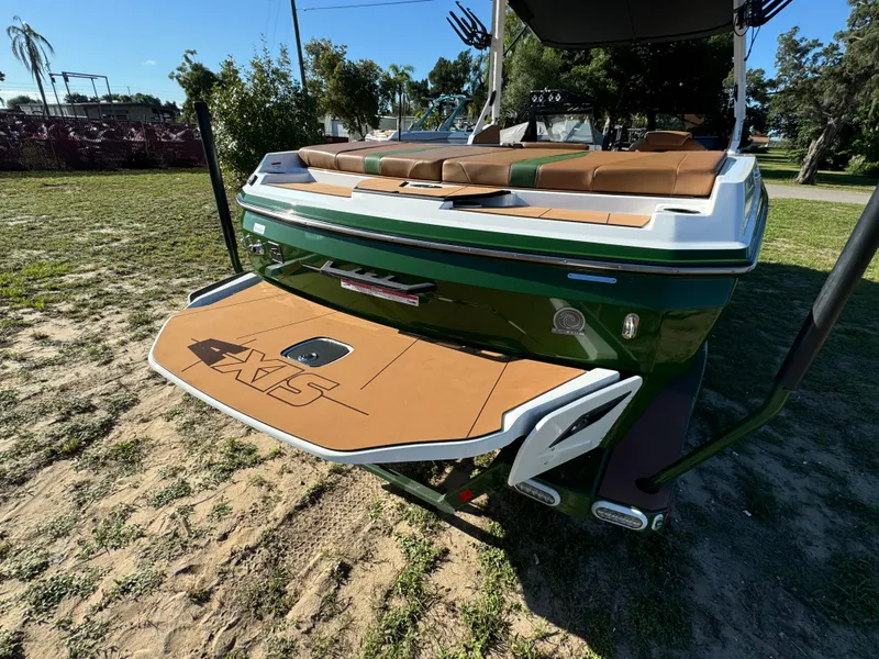 Slide: The Image of 2023 Axis A225 boat with tan and green seating, rear view. - 45