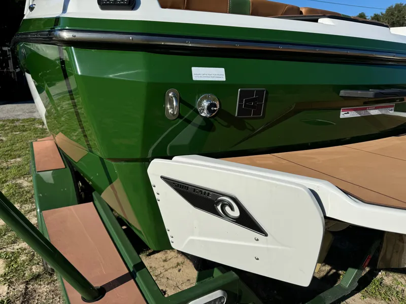 Slide: The Image of 2023 Axis A225 boat, green and white, rear view with swim platform. - 46