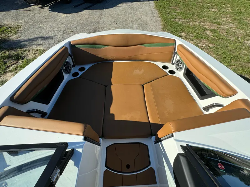 Slide: The Image of 2023 Axis A225 boat interior with tan seating and cup holders. - 8