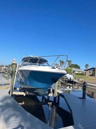 Slide: The Image of 2005 Fountain 38 LX boat docked under clear blue sky. - 1