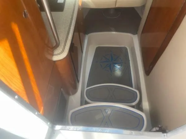 Slide: The Image of Interior view of 2005 Fountain 38 LX boat cabin with compass design mats. - 11