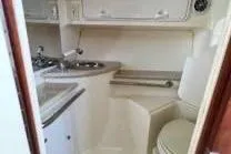 Slide: The Image of 2005 Fountain 38 LX boat interior with sink and toilet. - 13