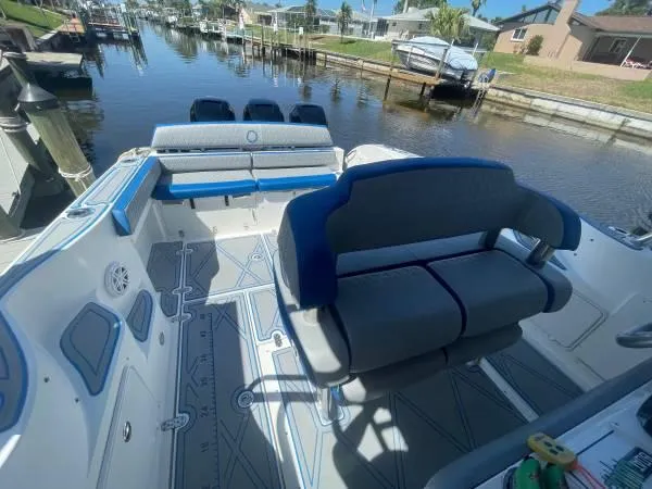 Slide: The Image of 2005 Fountain 38 LX boat interior with seating, docked in a canal. - 5