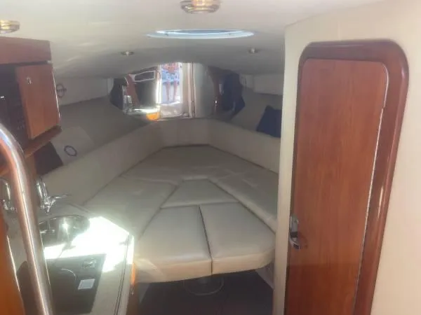 Slide: The Image of 2005 Fountain 38 LX cabin interior with beige seating and wooden accents. - 9