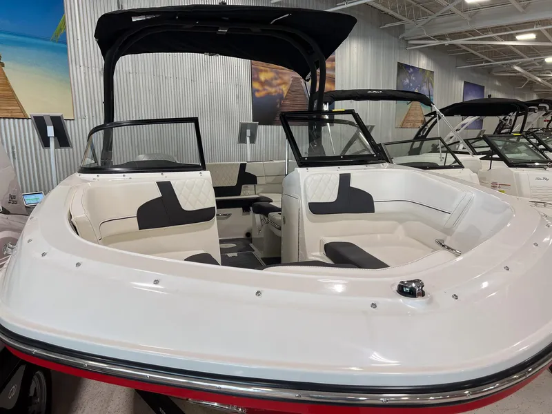Slide: The Image of 2023 Bayliner VR5 Bowrider boat interior with white and black seating, displayed indoors. - 10