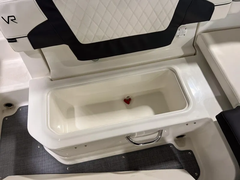 Slide: The Image of 2023 Bayliner VR5 Bowrider storage compartment with cushioned seating. - 11