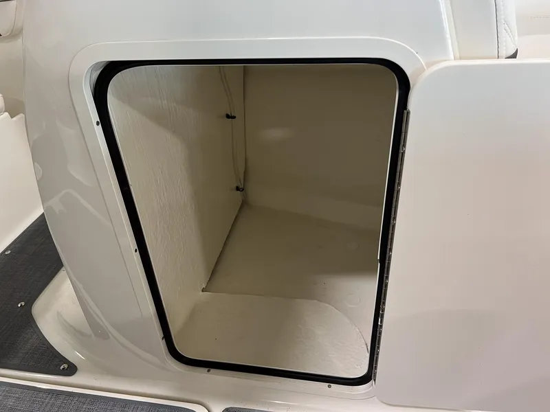 Slide: The Image of Open storage compartment on a 2023 Bayliner VR5 Bowrider boat. - 18