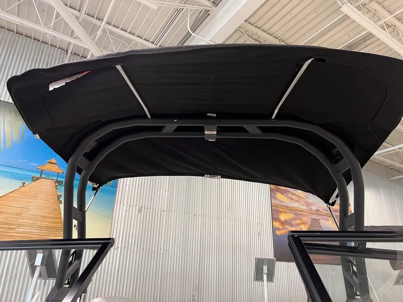 Slide: The Image of 2023 Bayliner VR5 Bowrider with black bimini top in showroom. - 23
