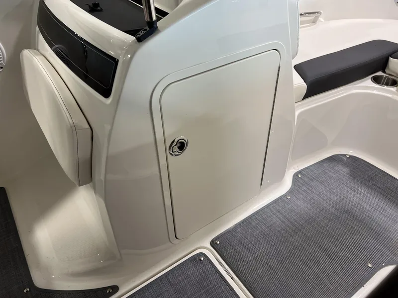 Slide: The Image of 2023 Bayliner VR5 Bowrider interior, featuring storage compartment and seating area. - 7