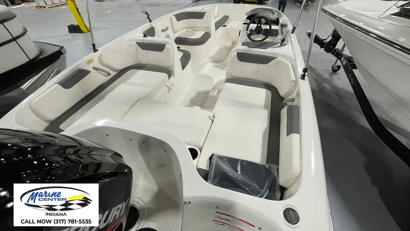 Slide: The Image of 2025 Bayliner E18LE boat interior with seating and steering wheel, displayed at Marine Center Indiana. - 10