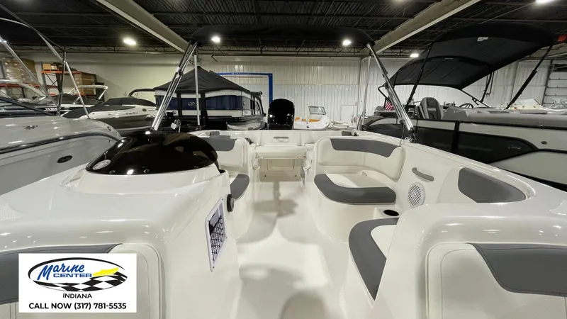 Slide: The Image of 2025 Bayliner E18LE boat interior with seating, displayed at Marine Center Indiana showroom. - 12