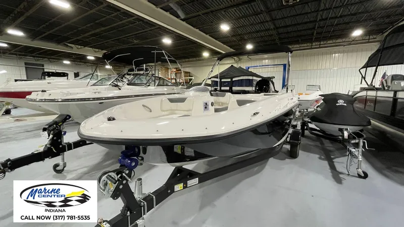 Slide: The Image of 2025 Bayliner E18LE boat displayed indoors at Marine Center Indiana. - 13