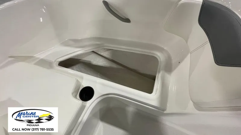 Slide: The Image of 2025 Bayliner E18LE boat interior storage compartment, Marine Center Indiana contact info visible. - 6