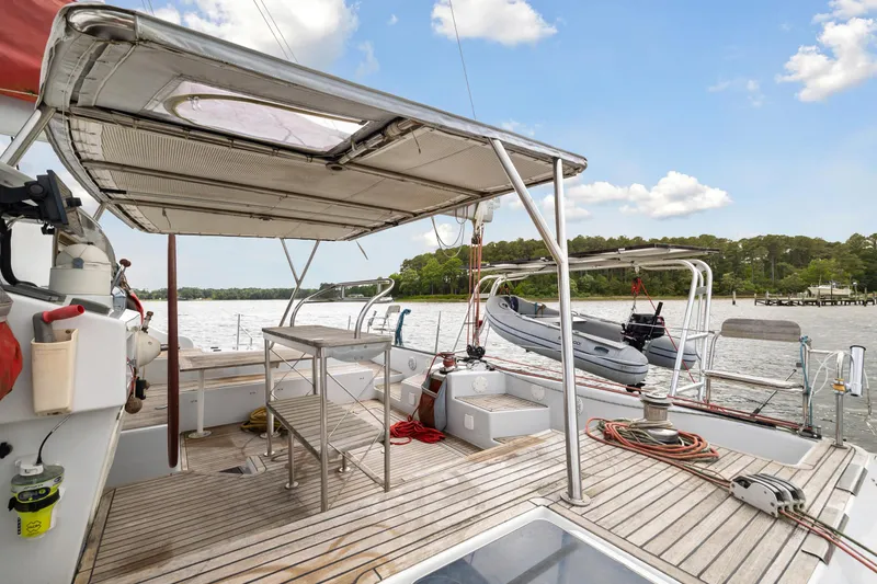 Slide: The Image of Deck of 2006 Switch 55 sailboat with canopy, table, and scenic water view. - 12