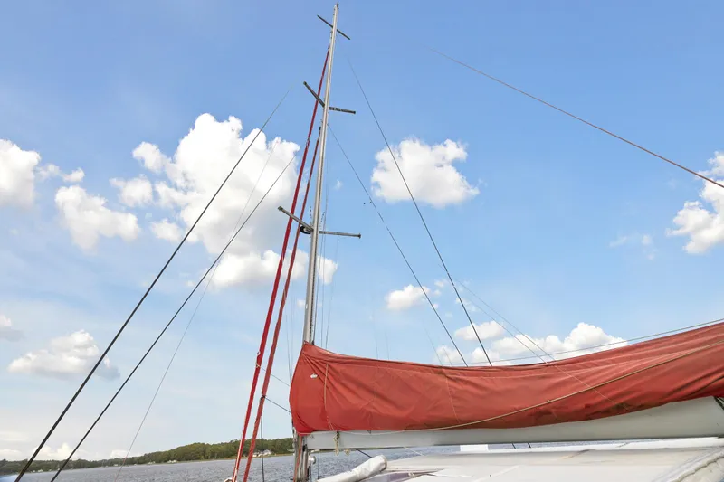 Slide: The Image of Sailboat with red sail cover under blue sky, Switch 55 model, 2006. - 14