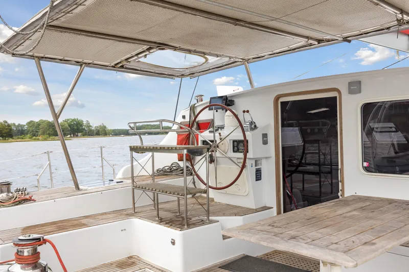 Slide: The Image of Switch 55 yacht deck with steering wheel, table, and canopy, 2006 model. - 17