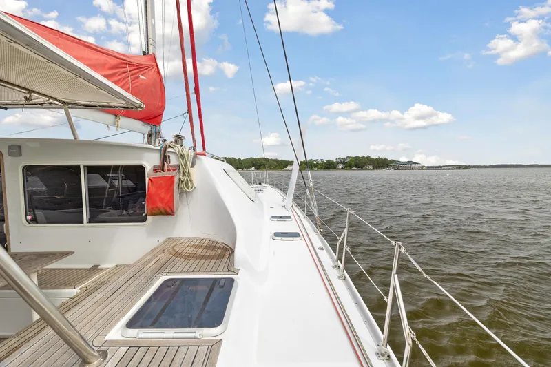 Slide: The Image of Sailing on a 2006 Switch 55 catamaran with red sails on a sunny day. - 19