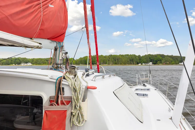 Slide: The Image of Sailing boat Switch 55 (2006) with red sails on a calm lake. - 20