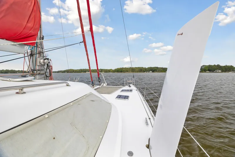 Slide: The Image of Sailing on a 2006 Switch 55 catamaran with red sails on a sunny day. - 21