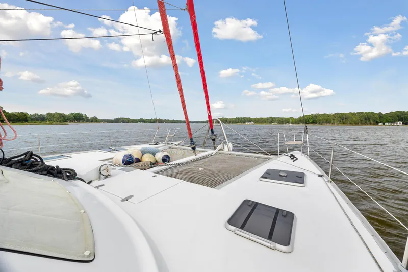 Slide: The Image of Sailing on a 2006 Switch 55 catamaran with red sails on a calm lake. - 24