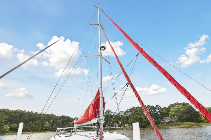 Slide: The Image of Sailboat Switch 55 (2006) with red sails on a sunny day. - 26