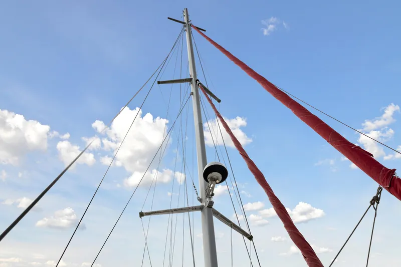 Slide: The Image of Sailboat mast and rigging against a blue sky with clouds, Switch 55, 2006 model. - 28